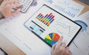 businesswoman using tablet analysis graph company finance strategy statistics success concept planning future office room 1 300x185 1